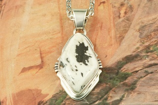 White Buffalo Turquoise set in Sterling Silver Pendant. This Beautiful Stone is formed from the minerals Calcite and Iron. It is mined near Tonopah Nevada. Free 18" Sterling Silver Chain with Purchase of Pendant. Created by Navajo Artist Arkie Nelson. Signed by the artist.